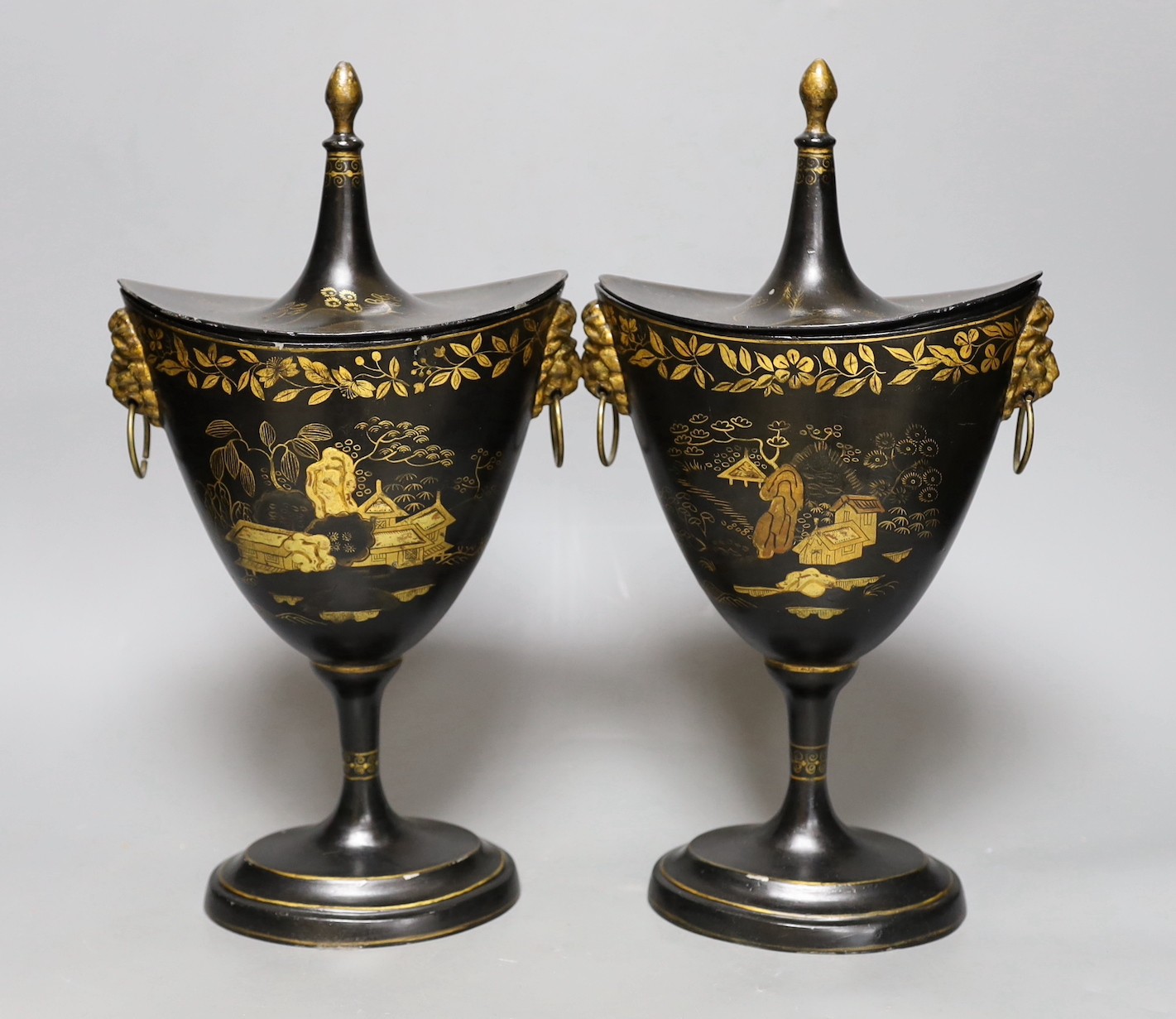 A pair of Japanned toleware urns and covers, 33cm tall